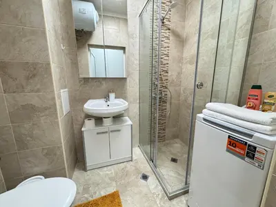 a bathroom with a toilet and a sink and a shower at Studio 108 by COSHER in Sofia