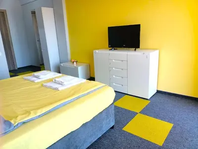 a bedroom with a bed and a tv on a dresser at Ubis Hotel in Krumovo