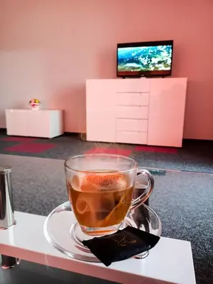 a cup of coffee on a plate on a table at Ubis Hotel in Krumovo