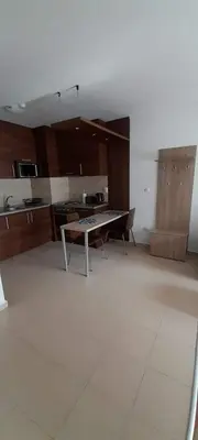 a living room with a table and a kitchen at Apartments Belvedere B303 in Bansko