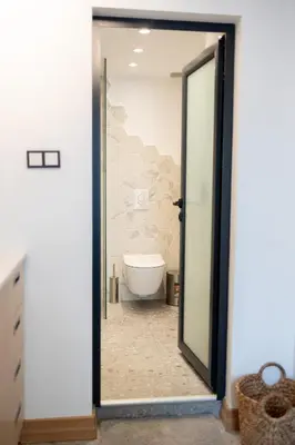a bathroom with a toilet and a glass door at Luxury studio 12-4 in Plovdiv
