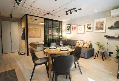 a living room with a table and chairs and a couch at NEW Oasis in the heart of Sofia in Sofia