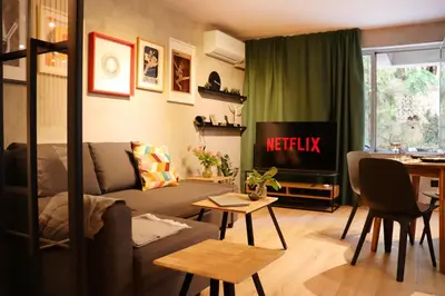 a living room with a couch and a tv at NEW Oasis in the heart of Sofia in Sofia