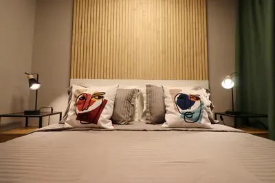 a bedroom with a bed with pillows on it at NEW Oasis in the heart of Sofia in Sofia