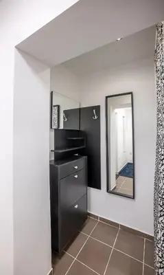 a bathroom with a black dresser and a mirror at Ukulele Place in Sofia