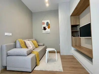 a living room with a couch and a tv at Via310 by Cosher in Sofia