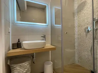 a bathroom with a sink and a glass shower at Via310 by Cosher in Sofia