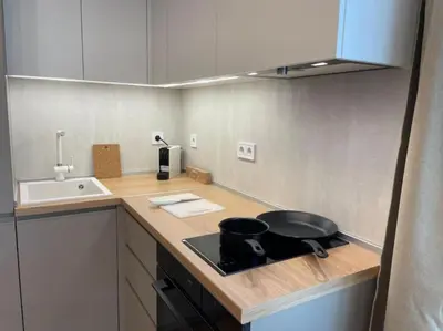 a kitchen counter with a frying pan on a stove at Via310 by Cosher in Sofia