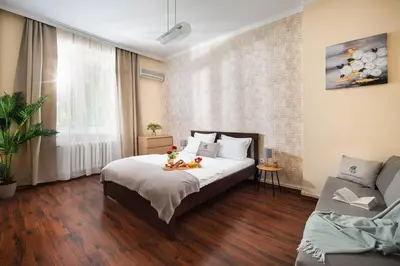 a bedroom with a bed and a couch at Your Spacious Home With Terrace & 3 Acs in Sofia