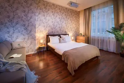 a bedroom with a large bed and a couch at Your Spacious Home With Terrace & 3 Acs in Sofia