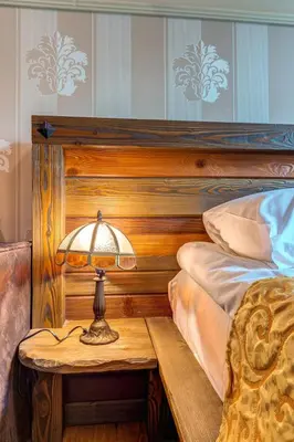 a bedroom with a bed and a table with a lamp at Cozy and Stylish Studio in Forest Glade by Flat Manаger in Pamporovo