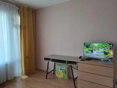 a room with a desk with a television on it at LevskiG Studio 10 min from Sofia Airport and city centre in Sofia