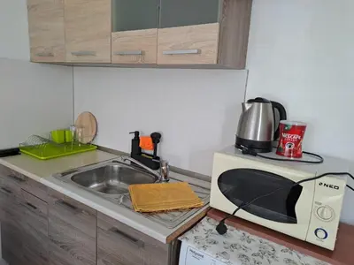 a kitchen counter with a microwave and a sink at LevskiG Studio 10 min from Sofia Airport and city centre in Sofia