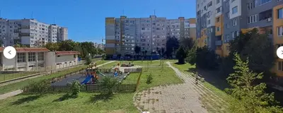 a park with a playground in a city with buildings at LevskiG Studio 10 min from Sofia Airport and city centre in Sofia