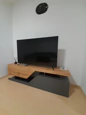 a flat screen tv sitting on top of a wooden entertainment center at Lux Apartament 4403 near the ski lift in Bansko