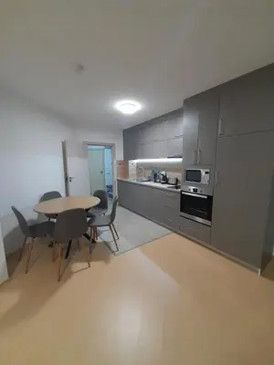 a kitchen with a table and chairs in a room at Lux Apartament 4403 near the ski lift in Bansko