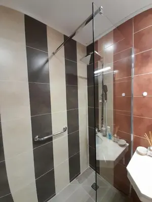 a shower with a glass door in a bathroom at Lux Apartament 4403 near the ski lift in Bansko