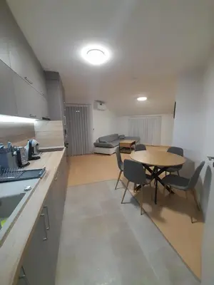 a kitchen and dining room with a table and chairs at Lux Apartament 4403 near the ski lift in Bansko