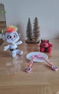 two stuffed animals sitting on a floor with a fork and a toy at Приветливо смарт студио, с изглед към Снежанка и ски писта Пампорово-Стойките in Stoykite