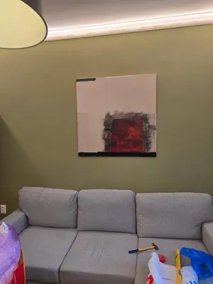 a couch in a living room with a painting on the wall at New Premium COZY apartment in the center next to NDK in Sofia