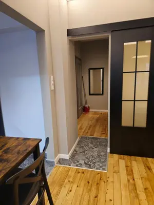 a hallway with a door and a table and chair at New Premium COZY apartment in the center next to NDK in Sofia
