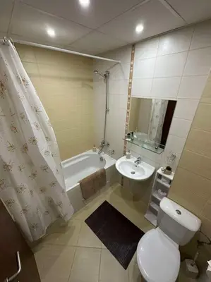 a bathroom with a toilet and a sink and a tub at large apartment in Borovets in Borovets