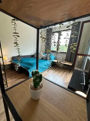 a room with a bed and a plant on a table at large apartment in Borovets in Borovets