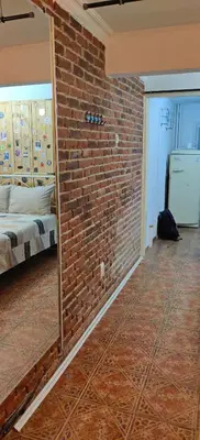 a room with a brick wall and a mirror at Artistic Atelier, Top Center - Vitosha Blvd in Sofia