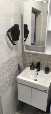 a bathroom with a white sink and a mirror at Студио Анастасия in Smolyan