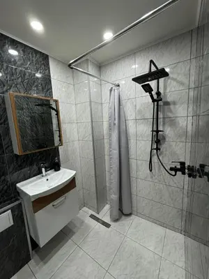 a bathroom with a shower and a sink at Апартамент LiAn in Plovdiv