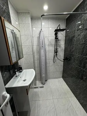 a bathroom with a shower and a sink and a shower at Апартамент LiAn in Plovdiv