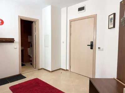 a hallway with a door and a red rug at Bansko&Ski in Bansko