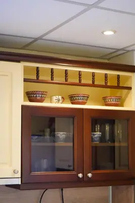 a wooden cabinet with bowls on top of it at Oborishte Family Elegance with Garden View in Sofia