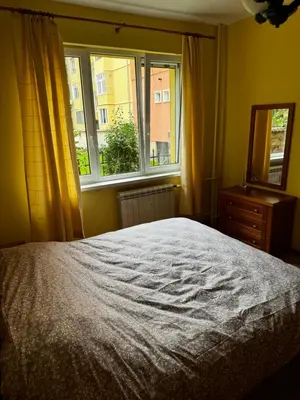a bedroom with a bed and a window at Oborishte Family Elegance with Garden View in Sofia
