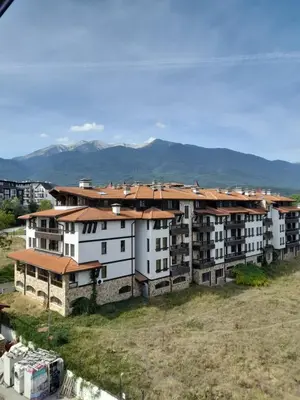 a group of apartment buildings with mountains in the background at Belvedere Holiday Club H79 in Bansko