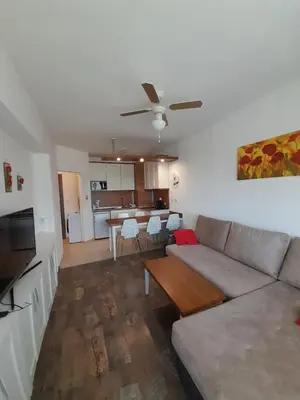 a living room with a couch and a table at Belvedere Holiday Club H79 in Bansko