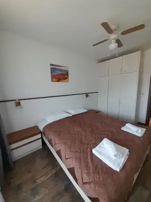 a bedroom with a bed and a ceiling fan at Belvedere Holiday Club H79 in Bansko