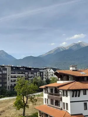 a city with buildings and mountains in the background at Belvedere Holiday Club H79 in Bansko