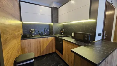 a kitchen with a sink and a microwave at MONTEVERDE Tamplier in Bansko