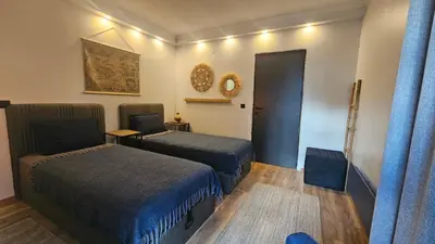 a hotel room with two beds and a mirror at MONTEVERDE Tamplier in Bansko