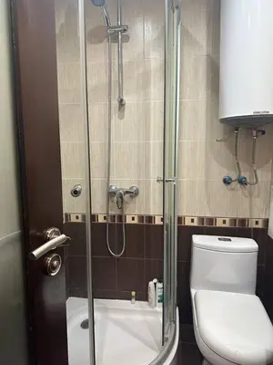 a bathroom with a glass shower with a toilet at Luxury Apartment Bansko in Bansko