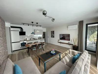 a living room with a couch and a table at Platinum Luxury Industrial Unit City-Center in Plovdiv