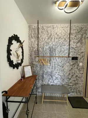 a room with a table and a mirror on a wall at Platinum Luxury Industrial Unit City-Center in Plovdiv
