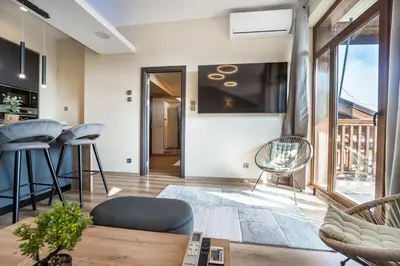 a living room with a couch and a table at Getaway 2 Bedroom Dream Apartment - free parking in Bansko