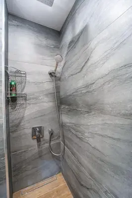 a shower with a hose attached to a wall at Getaway 2 Bedroom Dream Apartment - free parking in Bansko