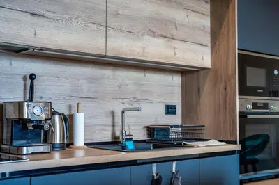 a kitchen with a counter top with a sink at Getaway 2 Bedroom Dream Apartment - free parking in Bansko