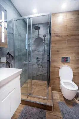 a bathroom with a toilet and a glass shower at Getaway 2 Bedroom Dream Apartment - free parking in Bansko