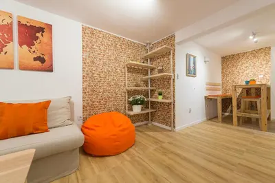 a living room with a couch and a wooden floor at Stylish apartment, Top center! in Sofia