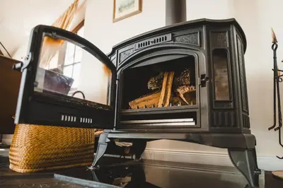 a black stove with a basket in a room at Newly Built Family Villa with a Hot Tub in Sopot