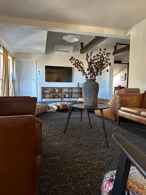 a living room with a vase on a table at Newly Built Family Villa with a Hot Tub in Sopot